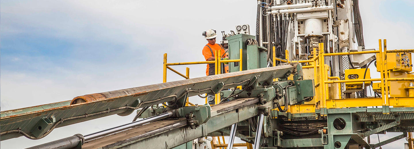Layne drilling equipment with a rig operator and rod handling machinery