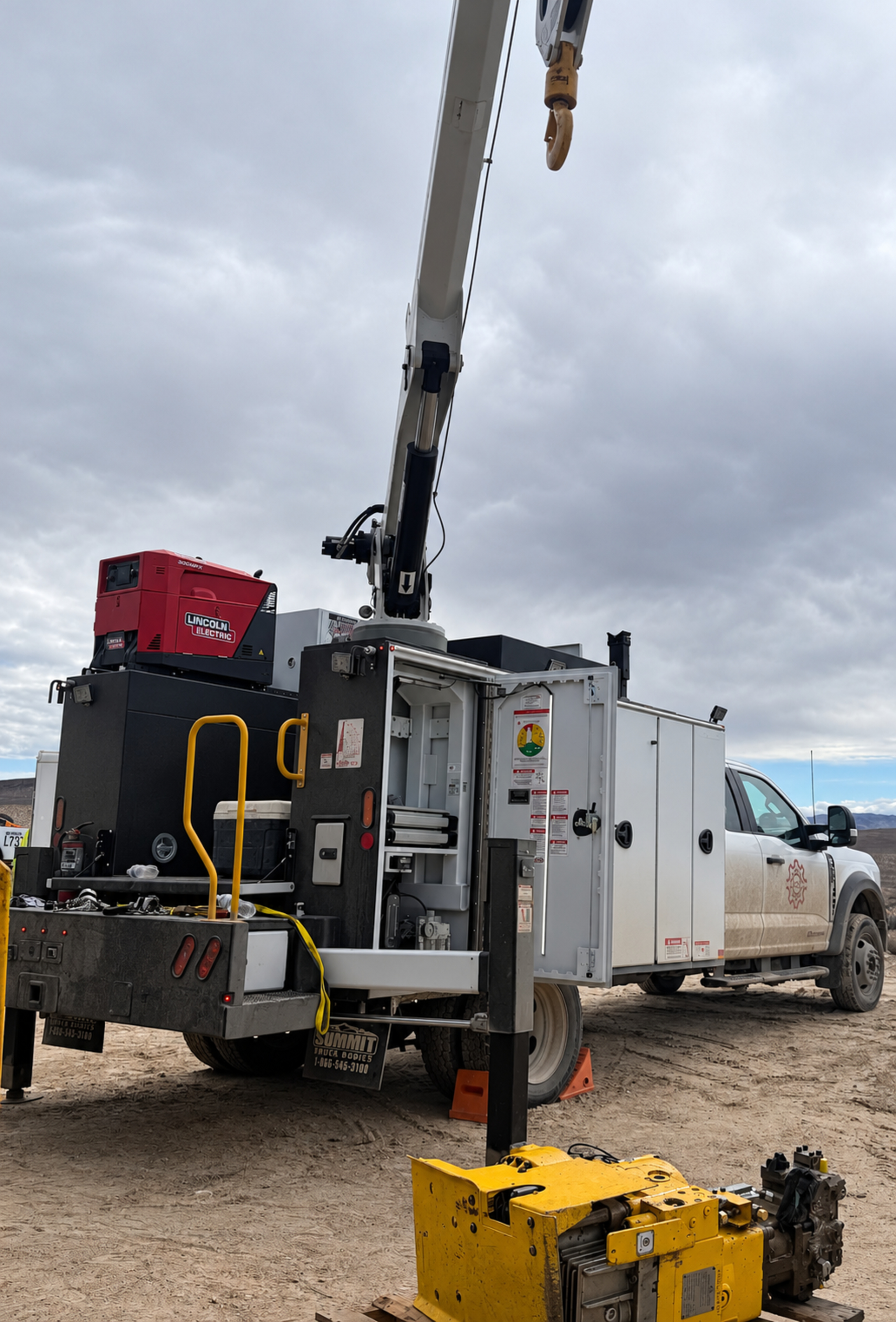 Mobile maintenance service truck with its crane extended at a drill site